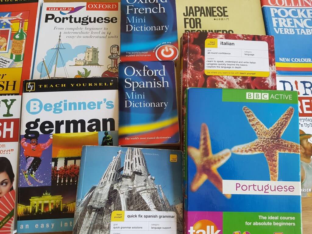 A pile of dictionaries and translation books - inferior to professional translation services